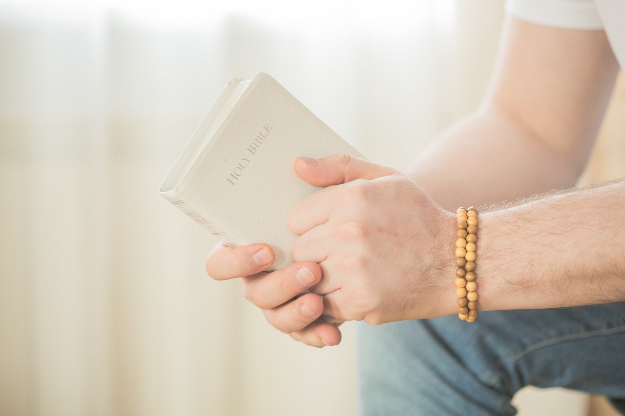 the-christian-holds-the-bible-in-his-hands-readin